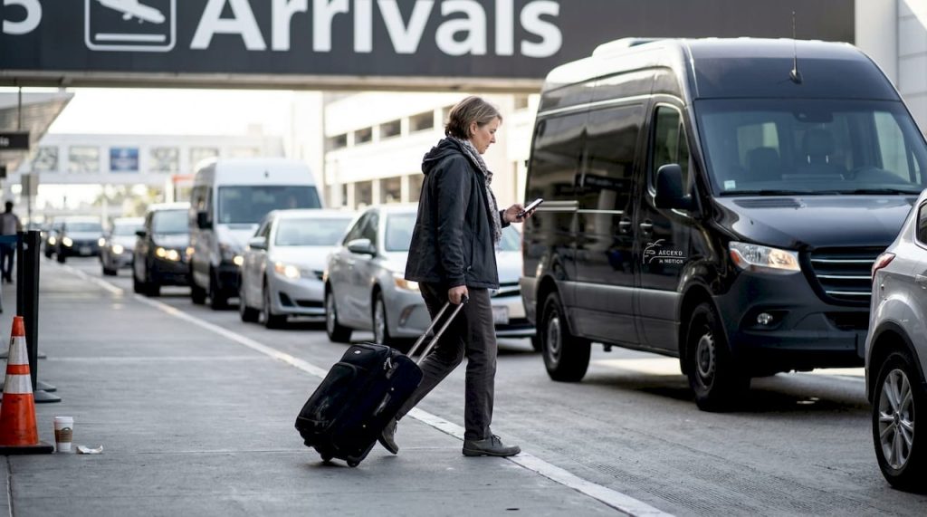 Traveler waiting at LAX terminal curb