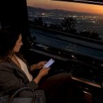 Traveler using phone navigation inside minivan
