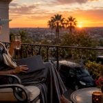 Traveler on terraced balcony at luxury LA hotel