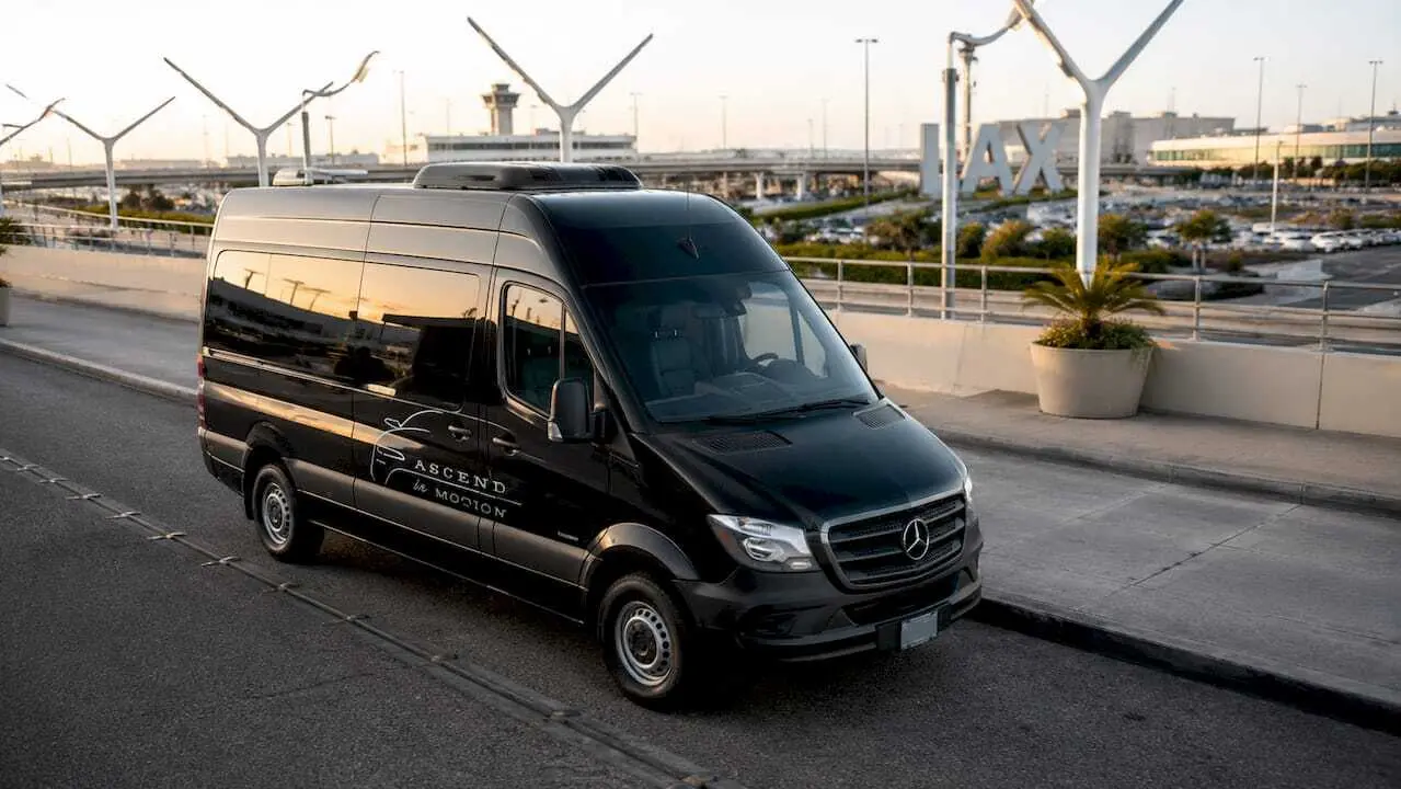 Ascend in Motion black Sprinter at airport curb