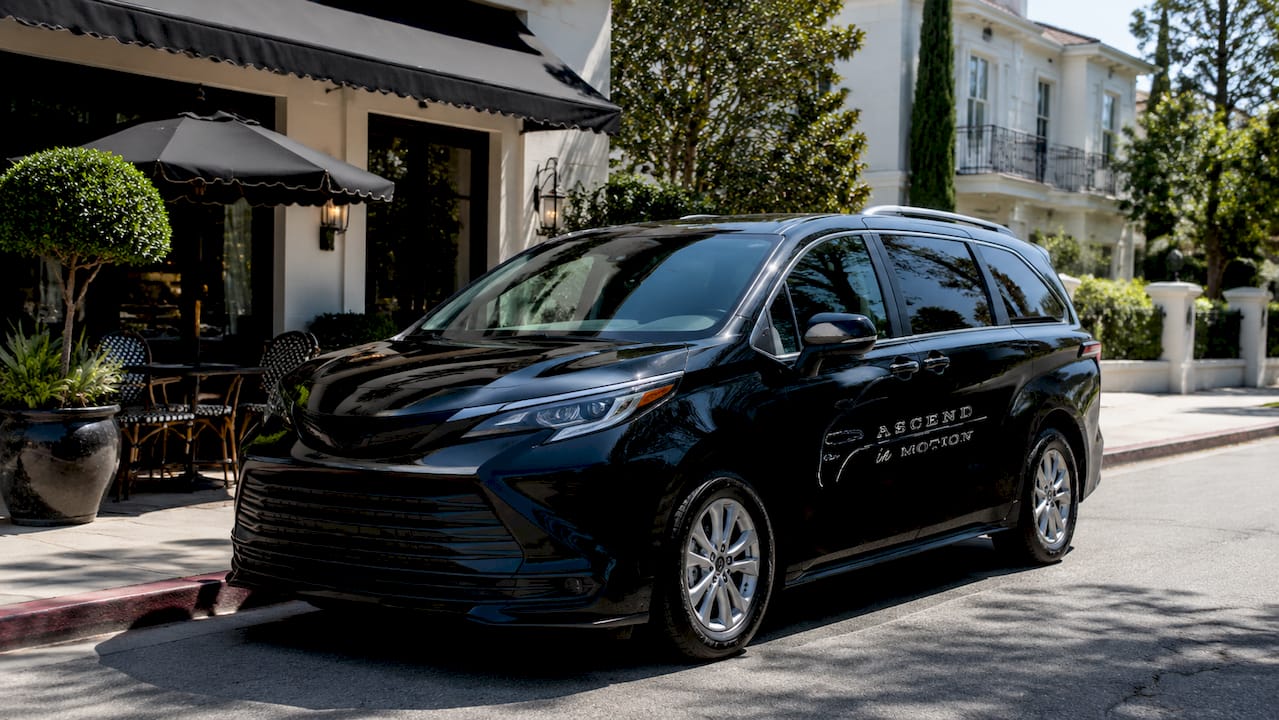 Black Ascend in Motion branded corporate minivan outdoors