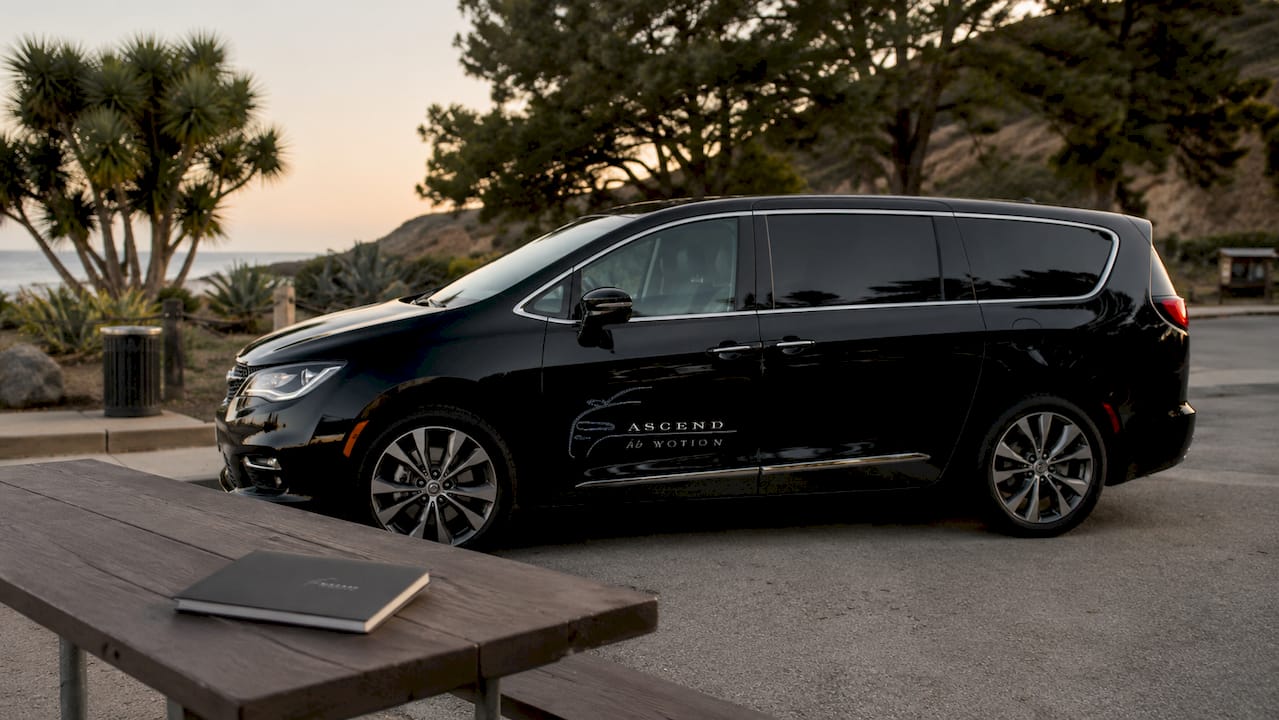 Black Ascend in Motion branded hotel shuttle minivan at LAX curbside