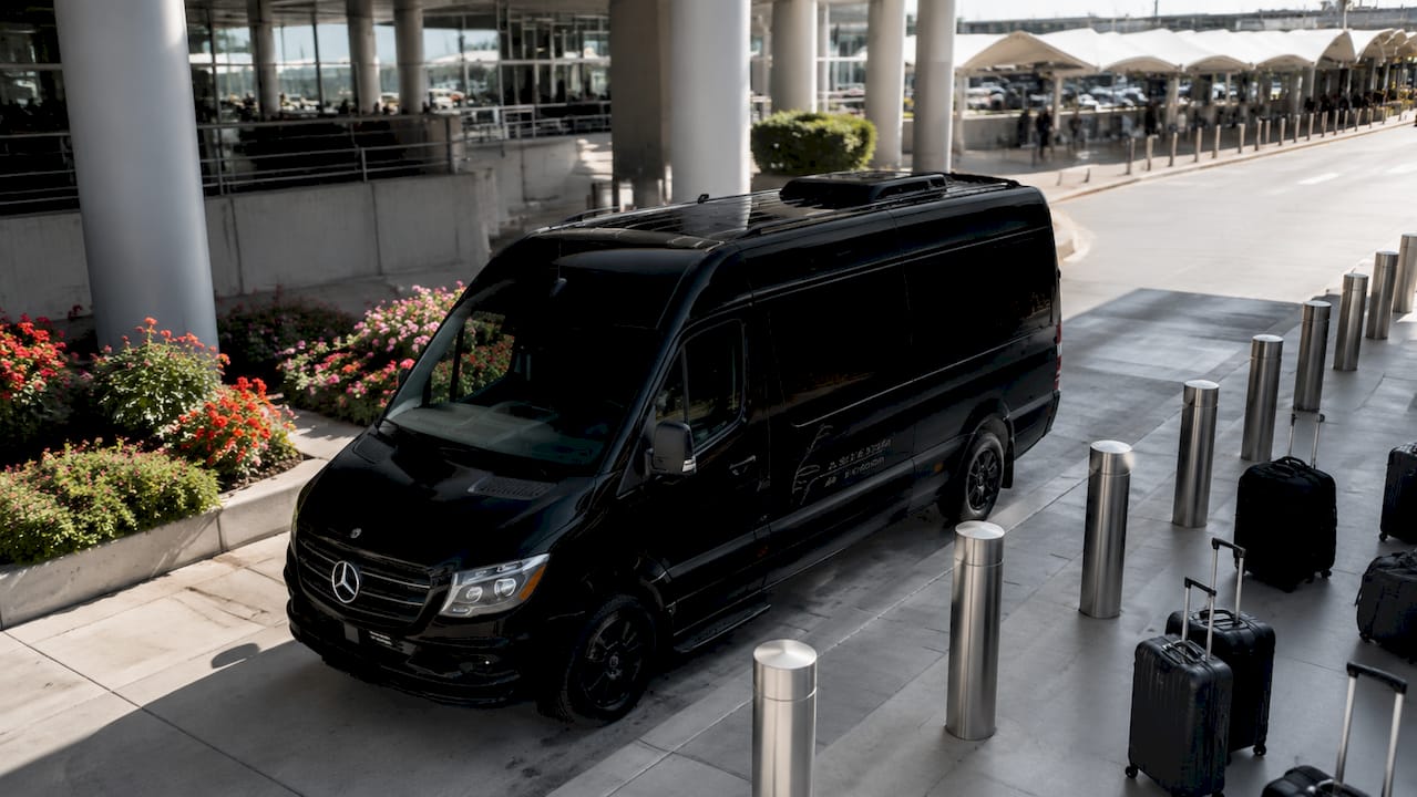 Black Ascend in Motion Mercedes-Benz Sprinter at airport curb
