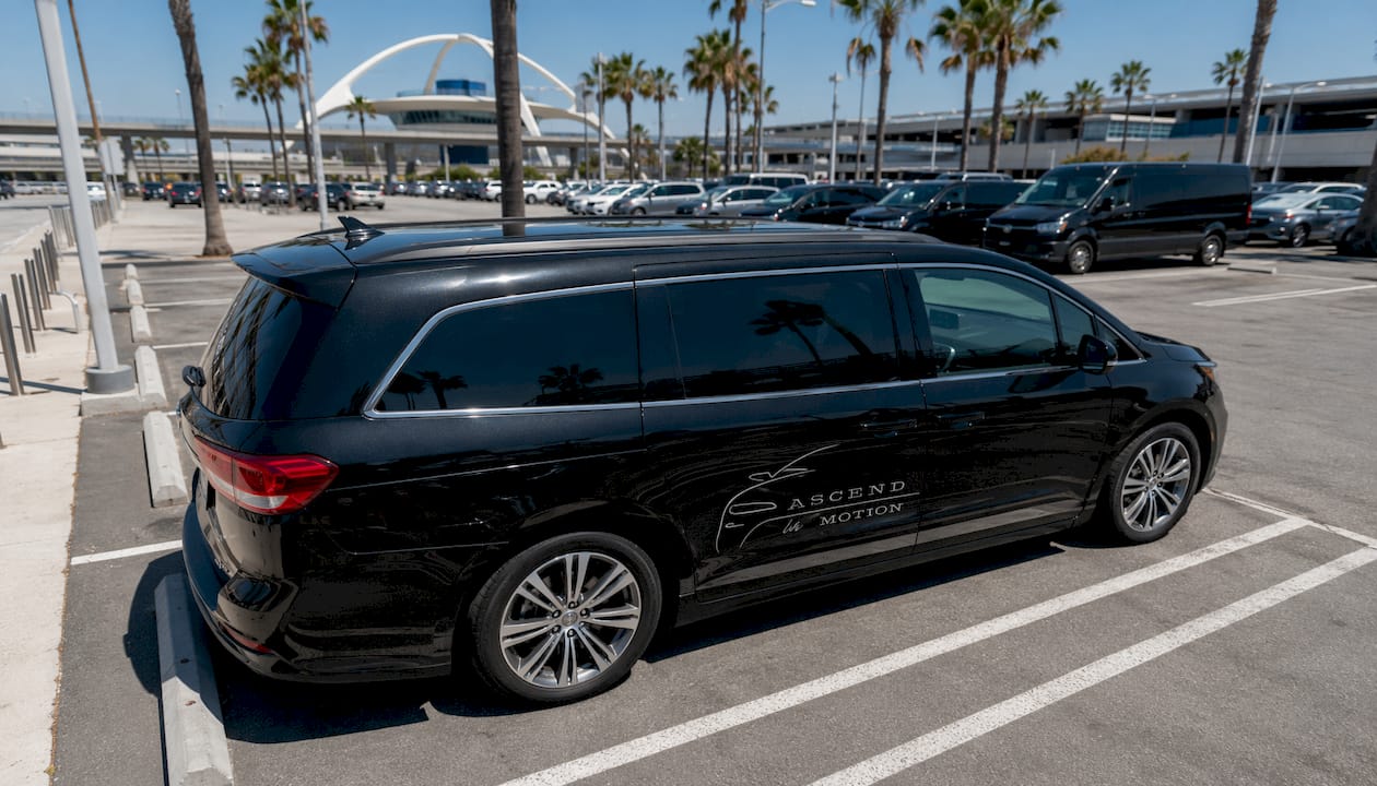 Black Ascend in Motion minivan at LAX curbside