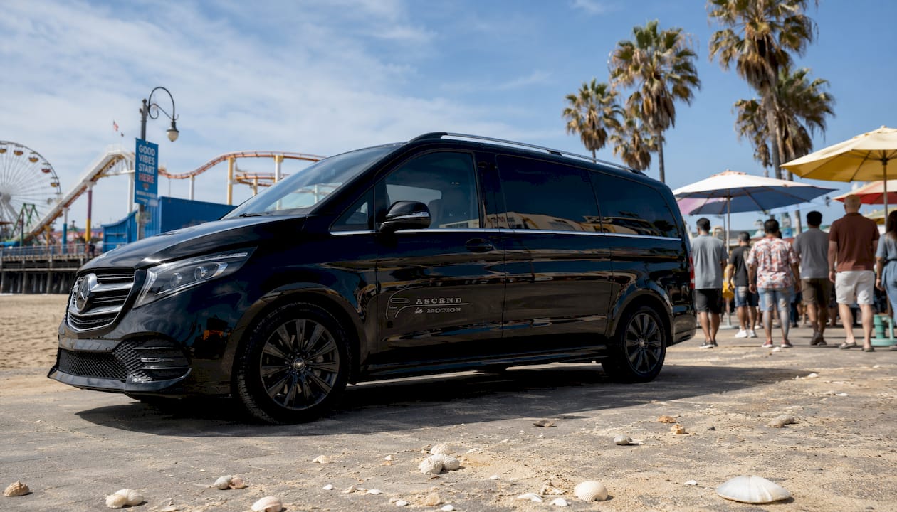 Ascend in Motion black minivan parked Santa Monica Pier