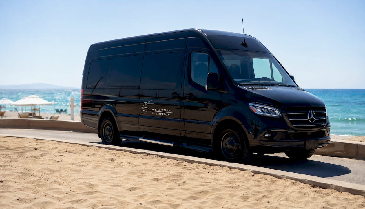 Black Mercedes-Benz Sprinter van parked at airport pickup