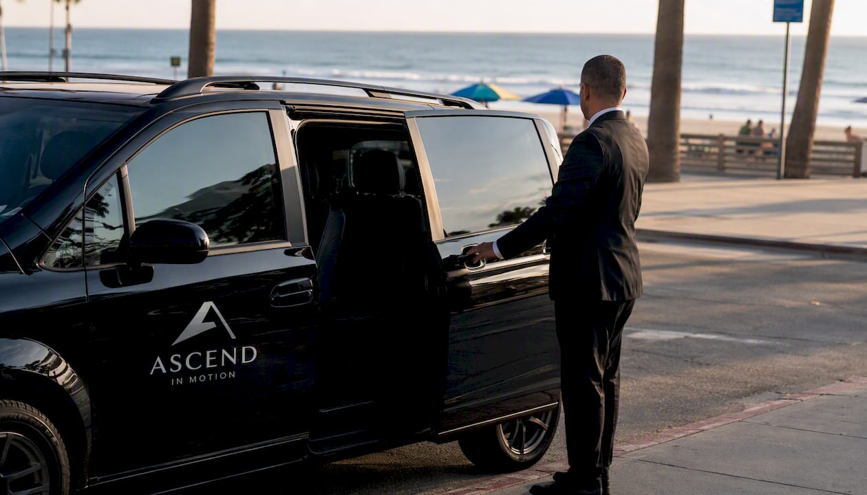 Ascend in Motion black minivan at LAX arrivals