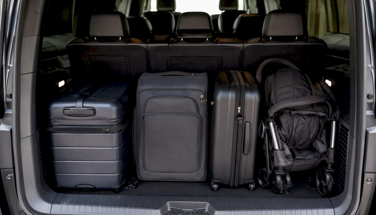 Luggage stored inside Ascend black minivan interior