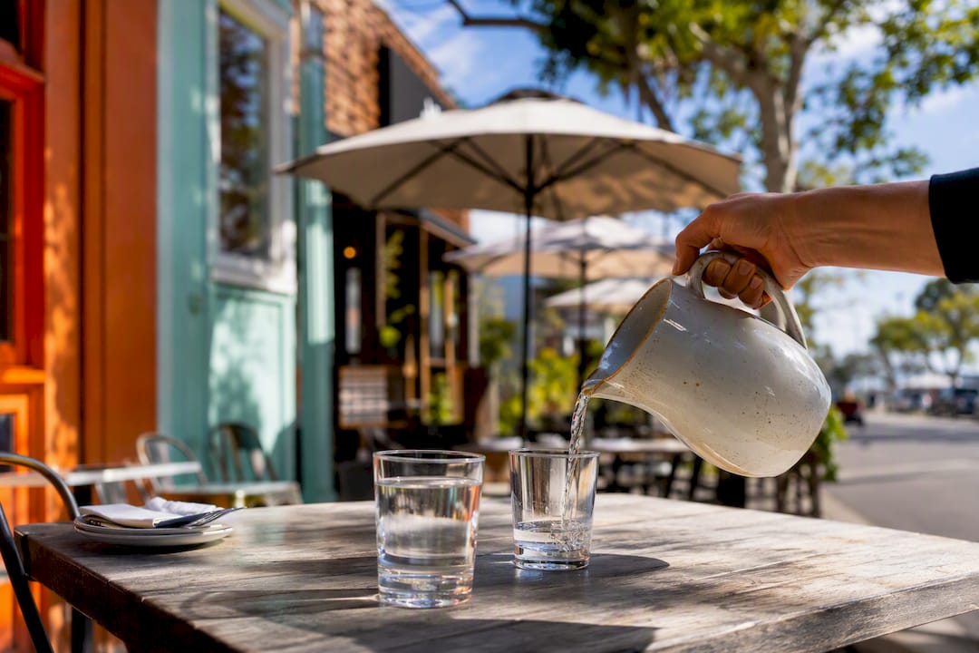 Outdoor dining with hand pouring drink in Ocean Park