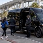 Black branded minivan arriving at SoFi Stadium