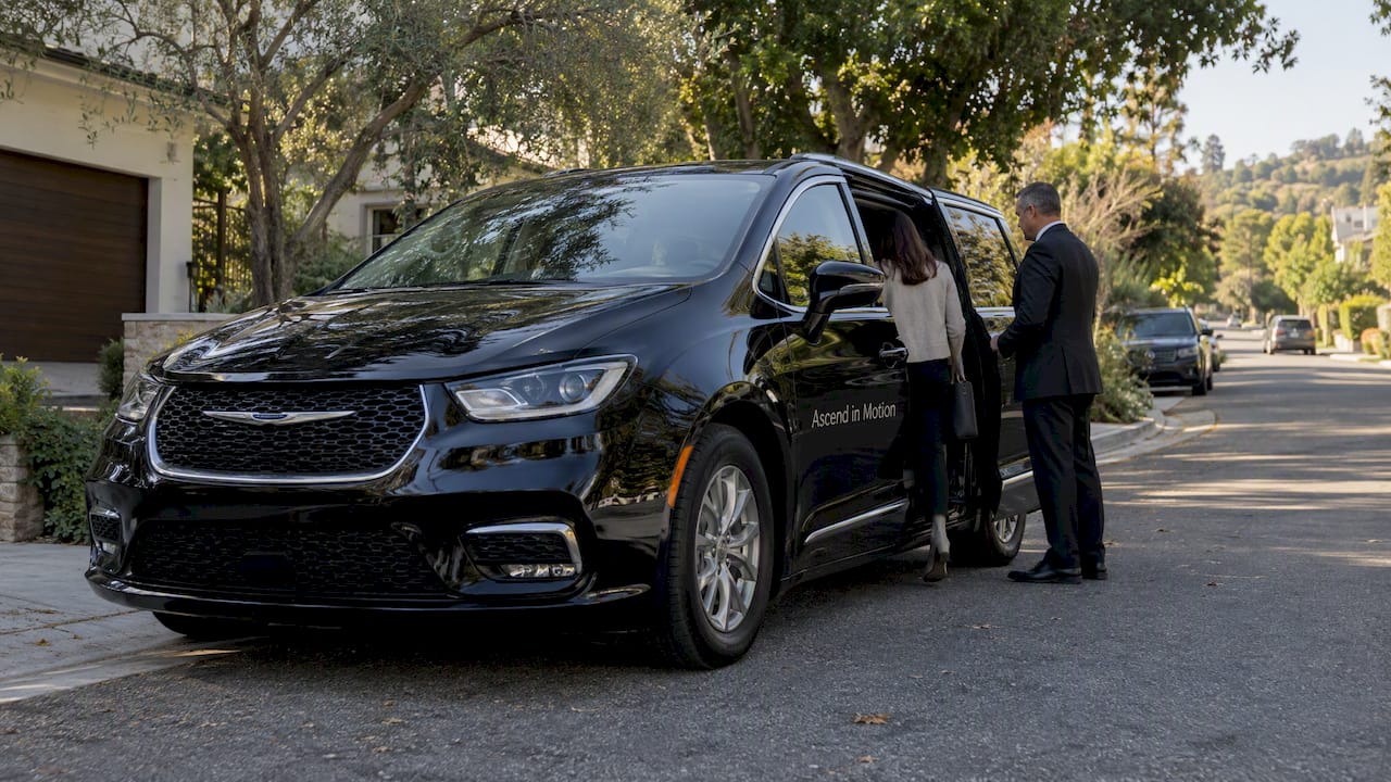 Branded black minivan at a Palisades home